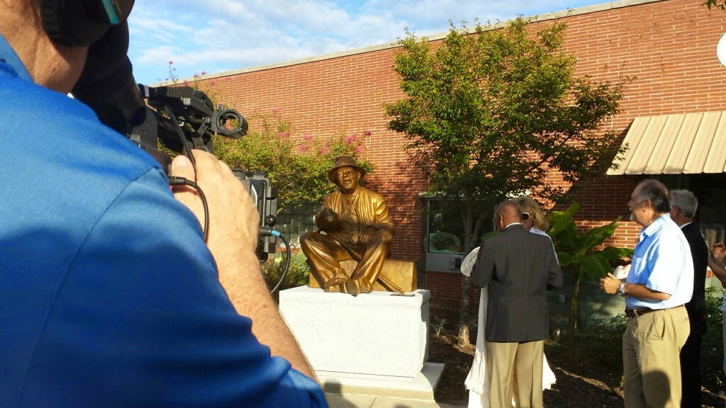 People admiring the sculpture now that it has been unveiled
