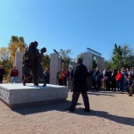 Alex Palkovich standing in front of the Home Safe monument after it was unveiled